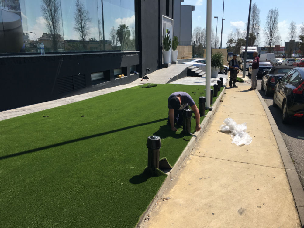 Fitter installing artificial grass