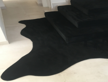 Black stair carpet spilling into room